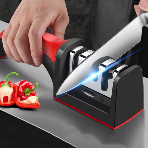Red and black 3-stage knife sharpener with knife inserted in three slots