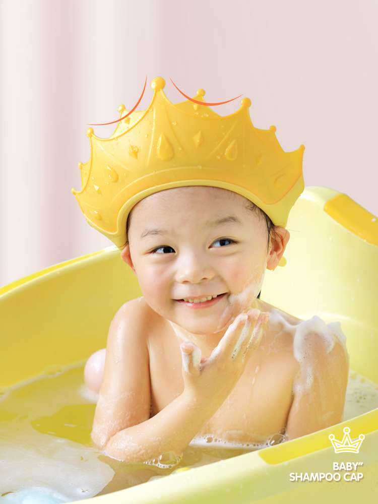 Baby Shower Bath & Shampoo Hat for Kids in yellow, worn by a smiling child during bath time.
